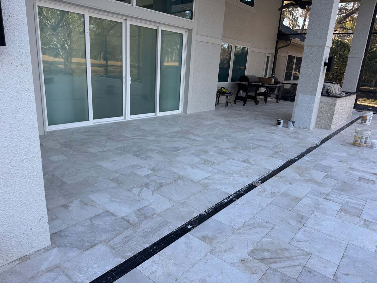 Covered lanai finished in large porcelain pavers