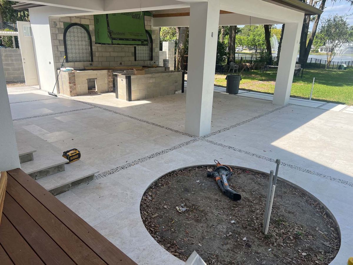 Lanai floor in porcelain pavers around a planter cutout