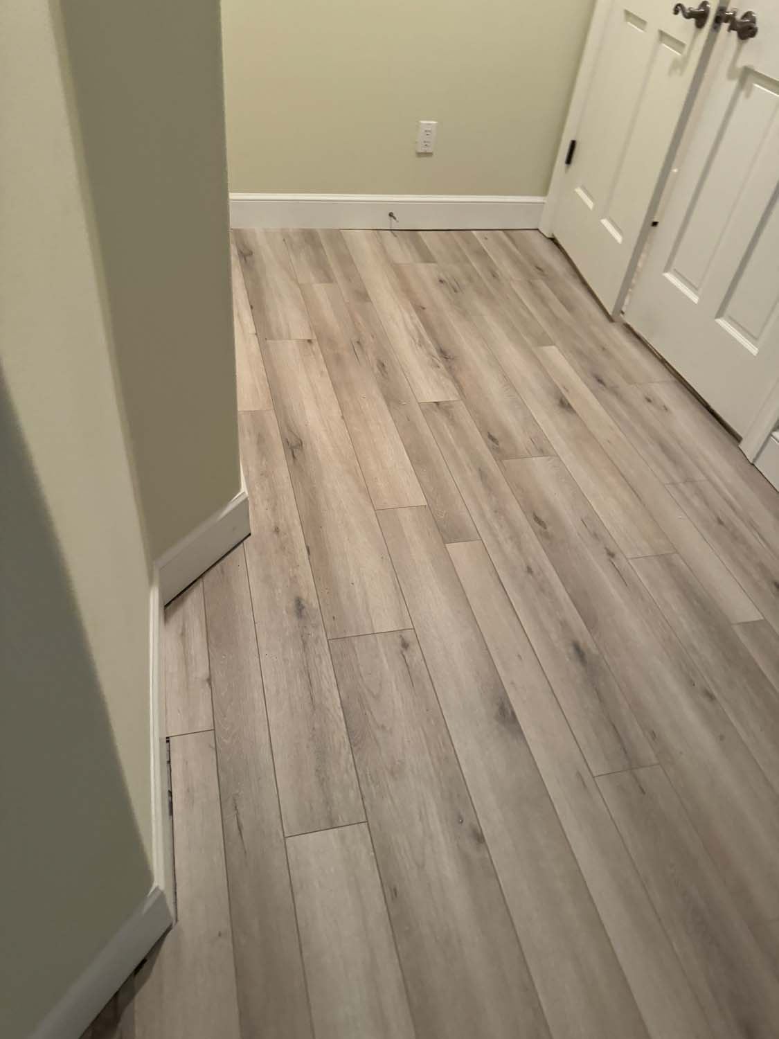 Wood-look plank tile running down a hallway