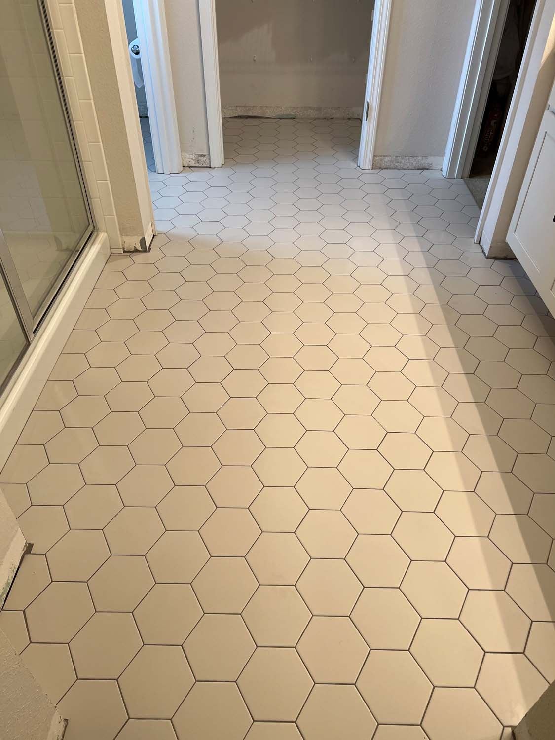 White hexagon floor tile in a hallway