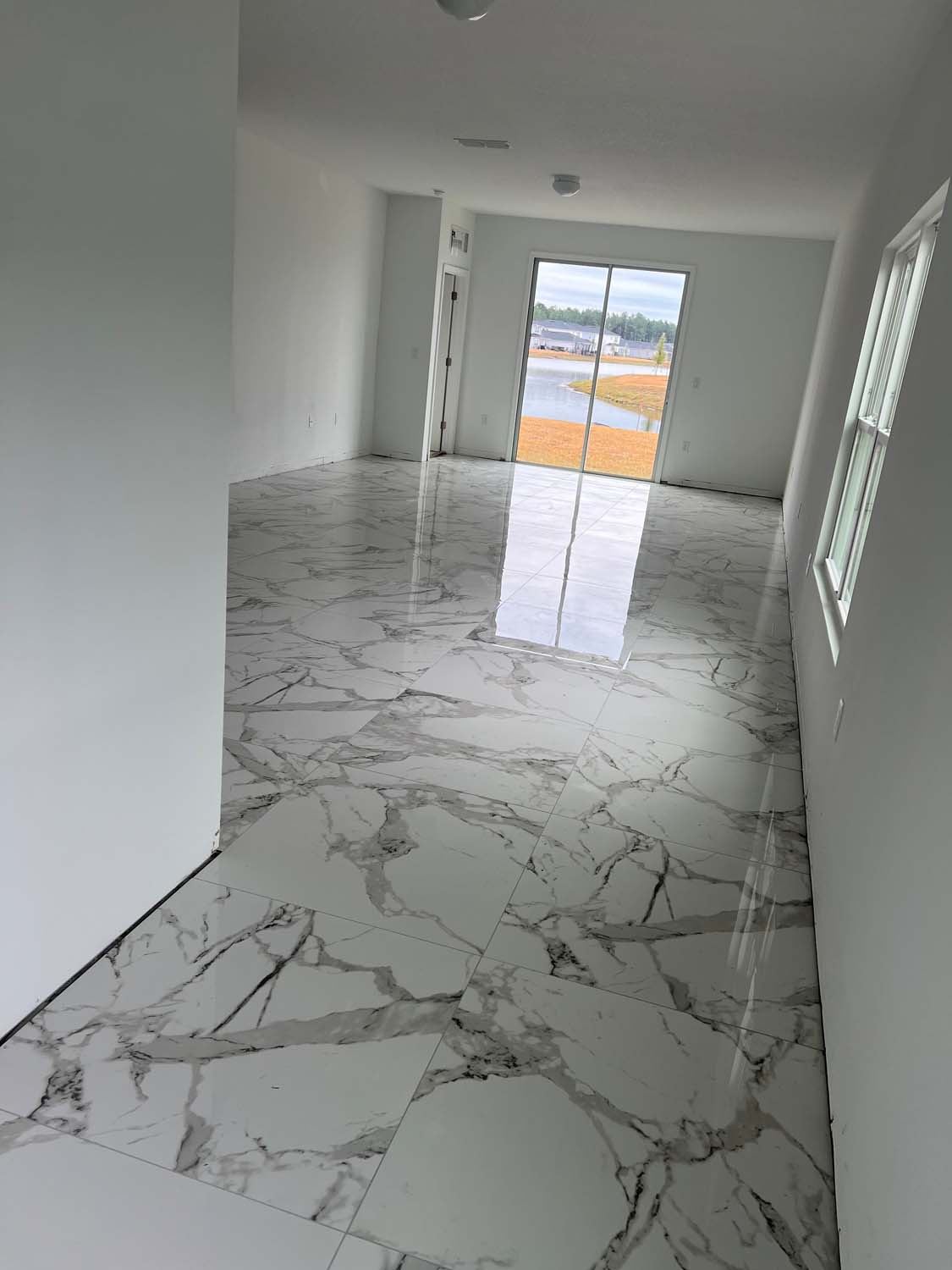 Calacatta-look large-format porcelain floor in an open room
