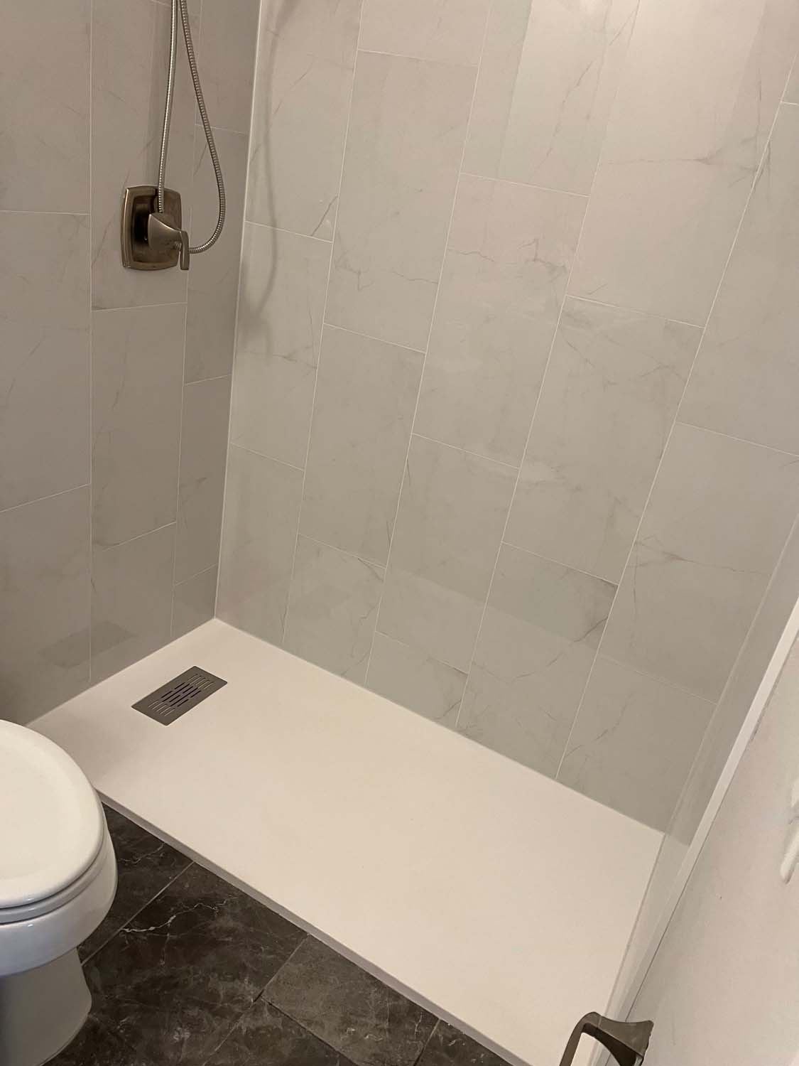 Porcelain shower with a low-profile pan and a slate floor