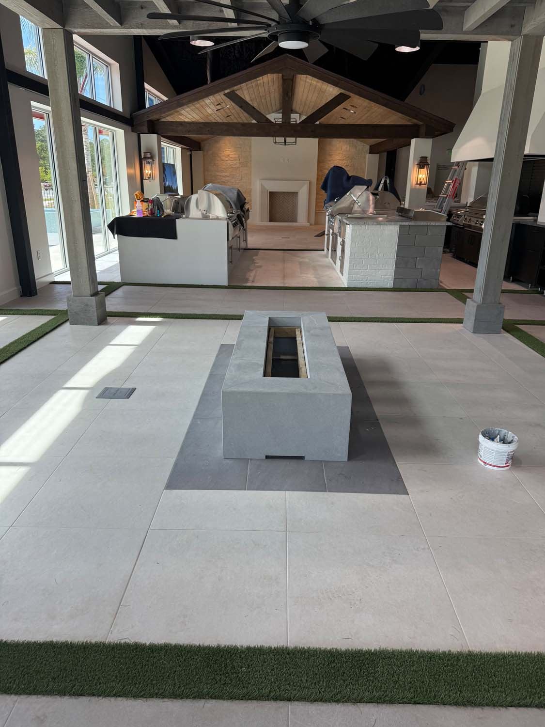 Large-format porcelain floor in a showroom around a fire table