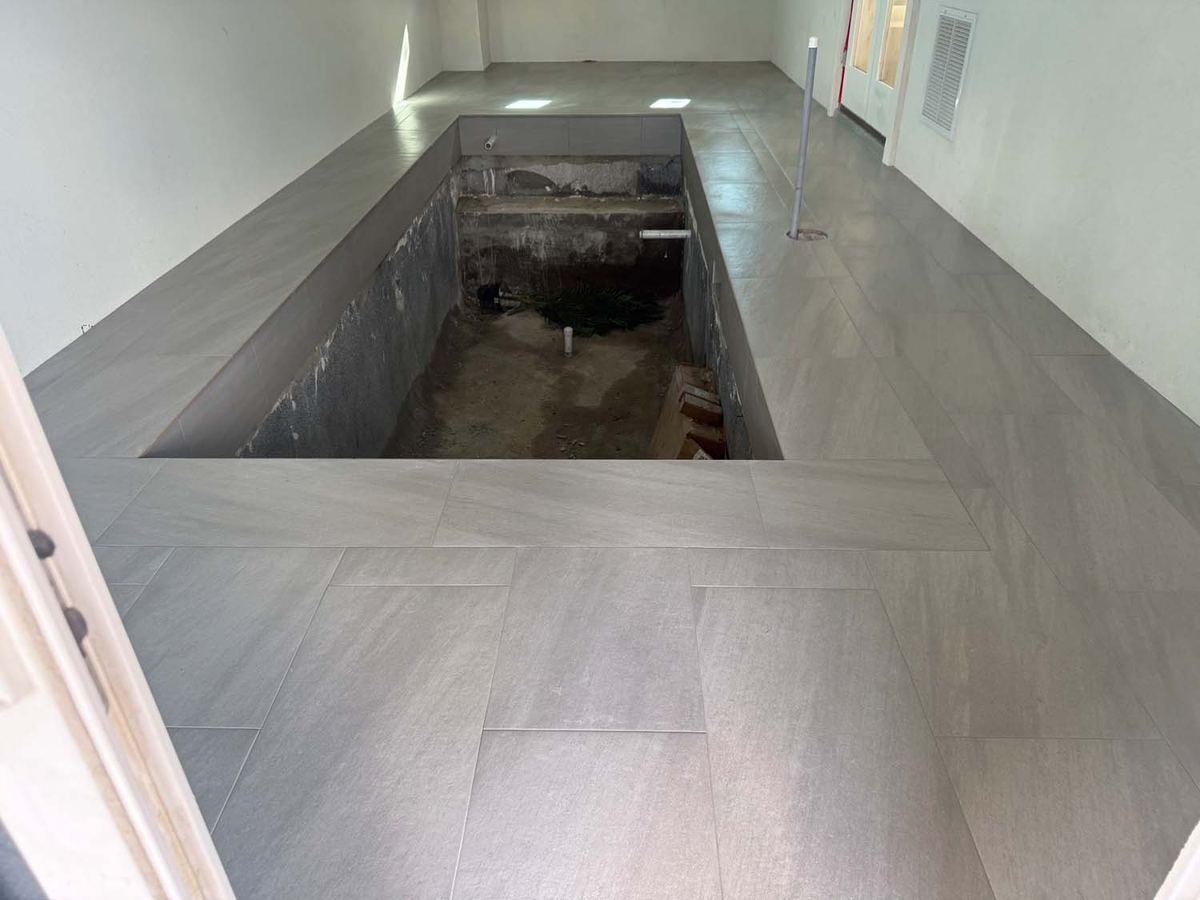 Large-format porcelain floor set around a sunken feature