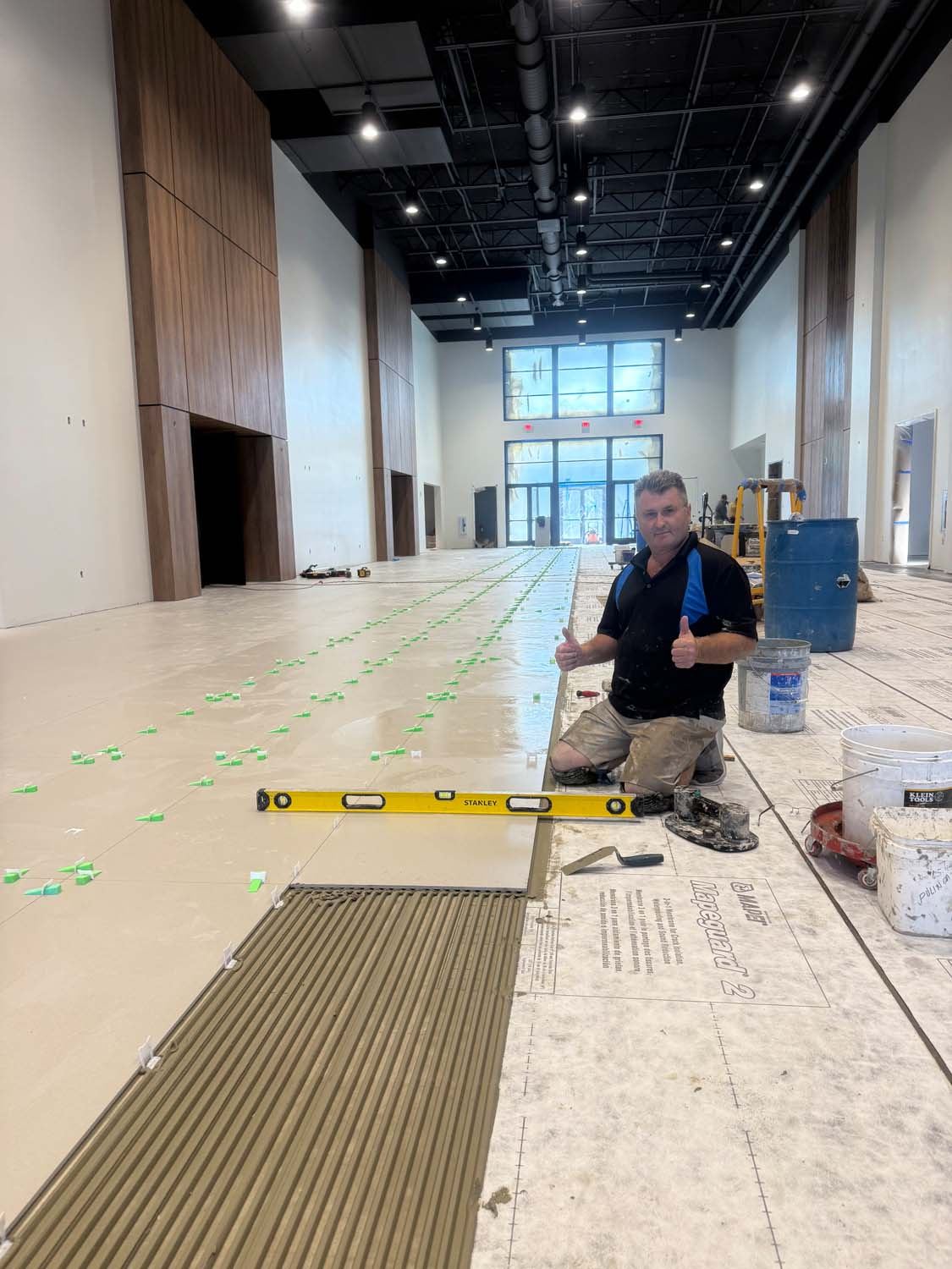 Konstantin setting large-format tile on a commercial job