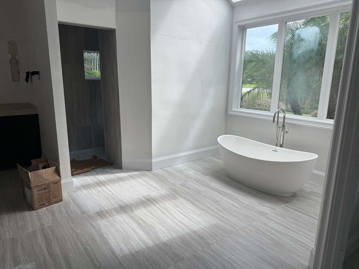 Wood-look plank tile in a bathroom with a freestanding tub
